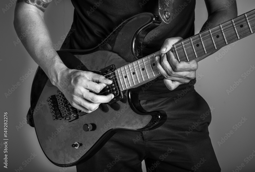 Young man playing a guitar.