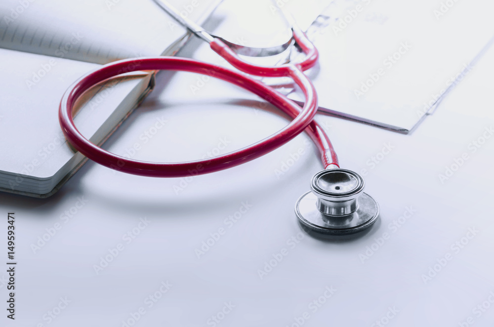 red stethoscope and Medical documents notebook