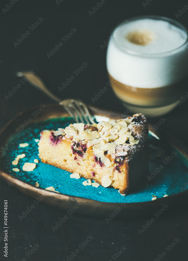 Dessert and coffee. Piece of lemon, ricotta, almond and raspberry gluten-free cake and glass of latt