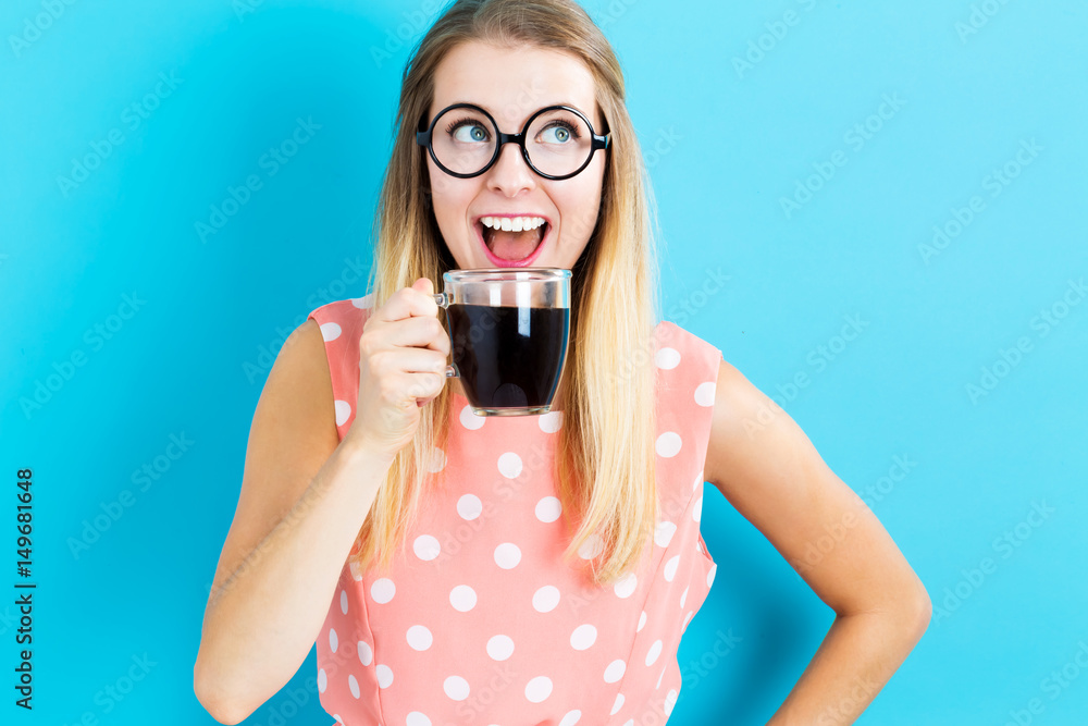 Happy young woman drinking coffee