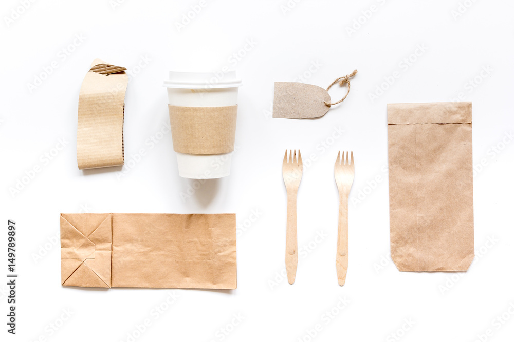 food delivery with paper bags and plastic cup on gray table background top view mockup