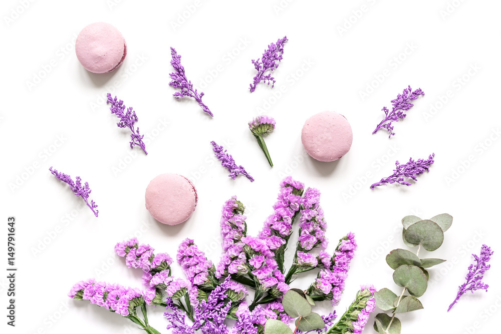 spring woman breakfast with macaroons and flowers white background top view