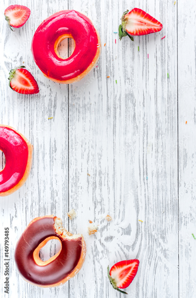 strawberry and chocolate donuts flat lay on wooden background top view mockup