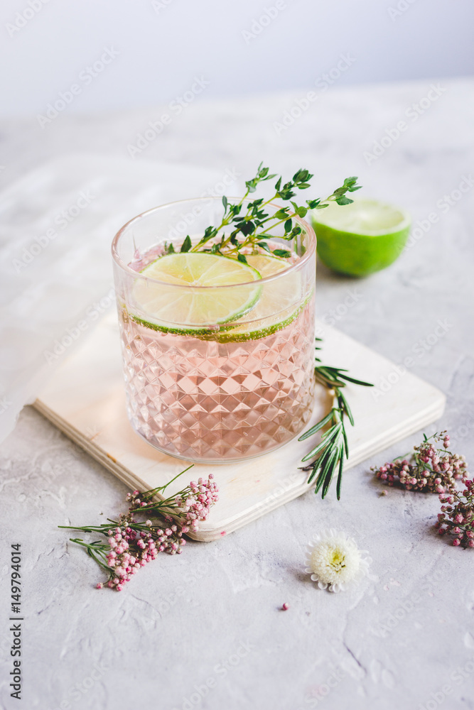 fresh homemade drink with flowers and lime on kitchen background