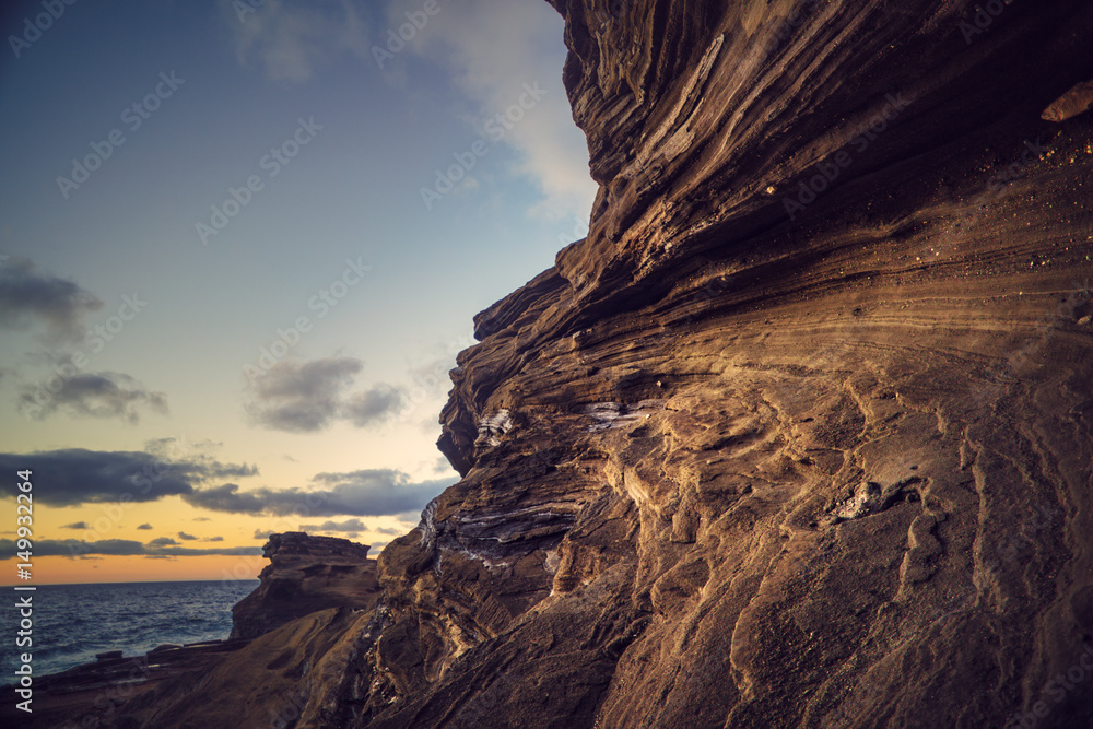 Rocky coastline with sunrise sky background