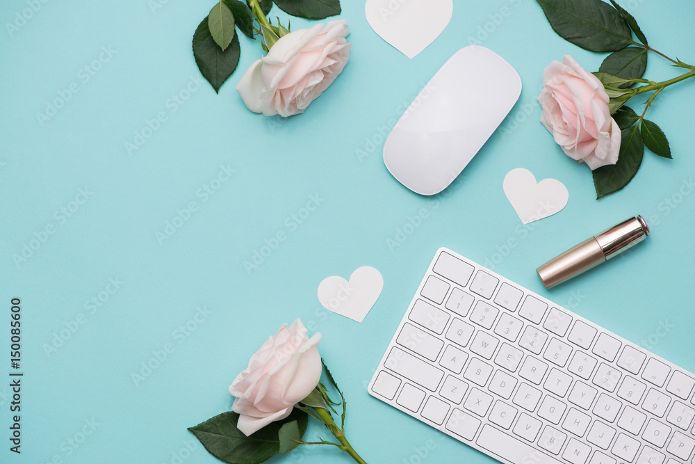 Mothers Day concept. Pink roses with gift box on woman office desk. Open notebook for copy space.