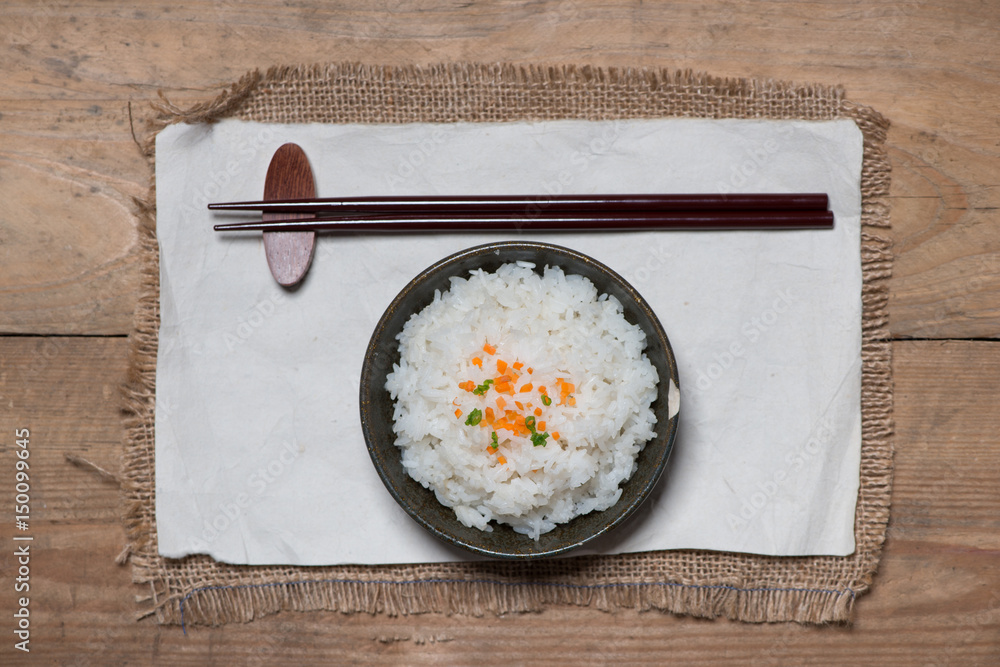 Close up of cooked rice in wooden in bowl on wooden table