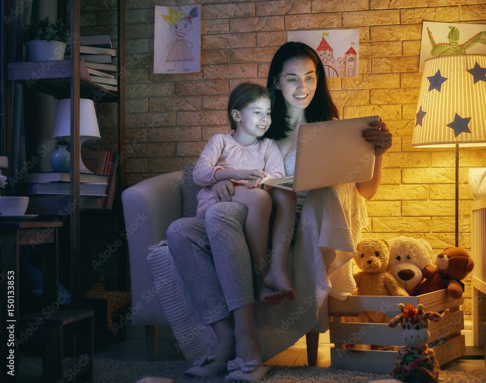 mother and her daughter with laptop