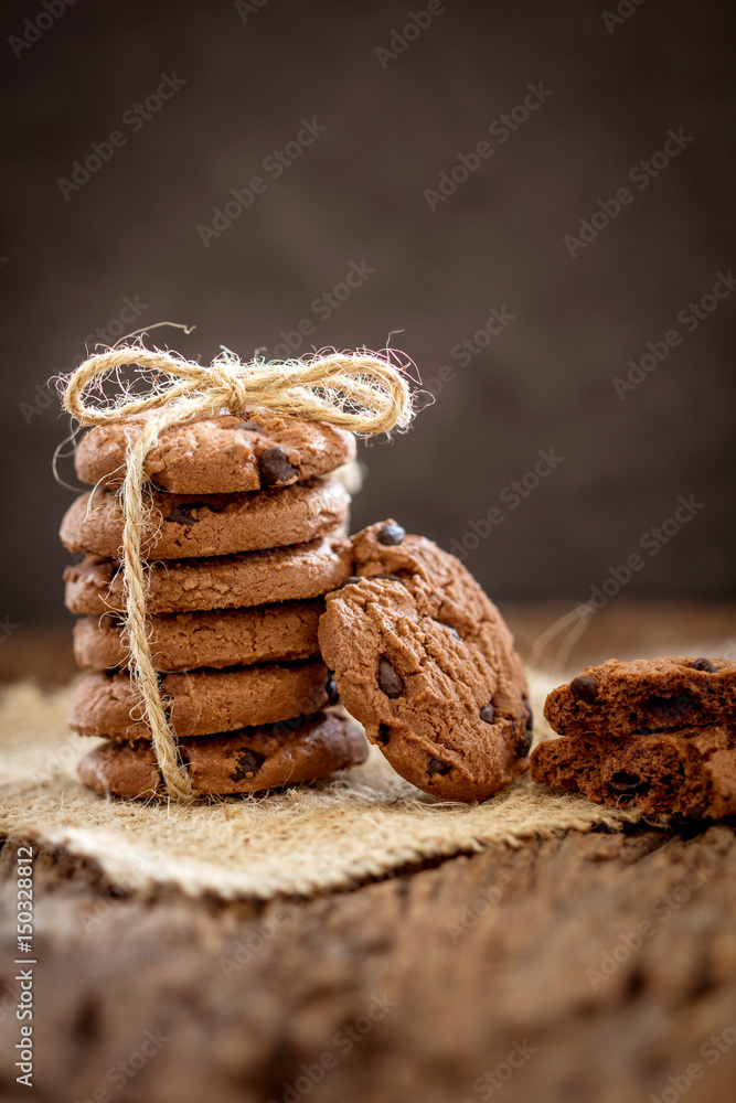 Still life of Close up stacked chocolate chip cookies on  napkin with rustic background