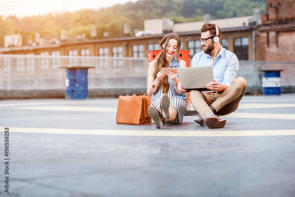 Business couple working outdoors on the heliport ground