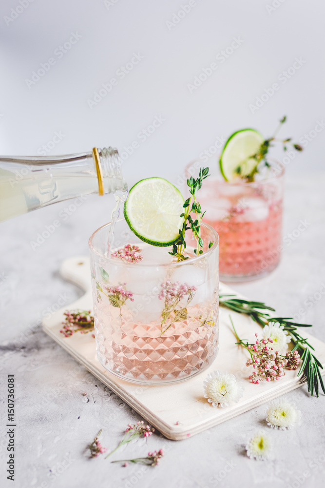 夏日自制果汁配石桌背景的酸橙和花朵