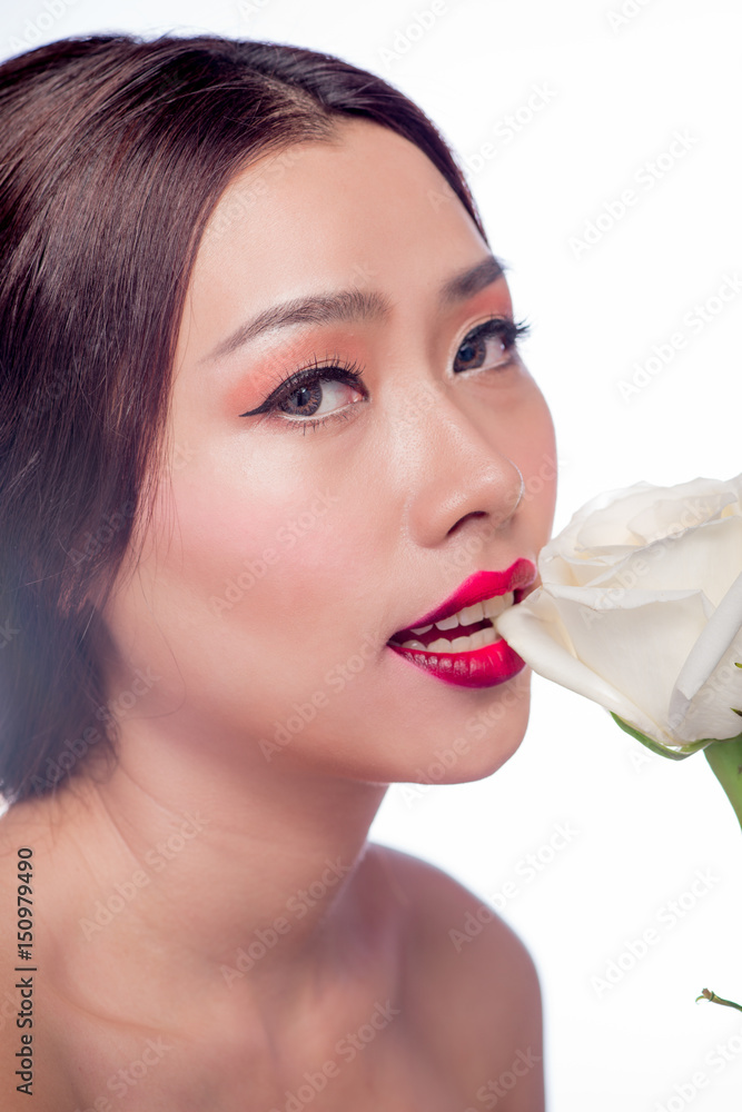 Beautiful asian woman face with perfect makeup with flowers of a rose