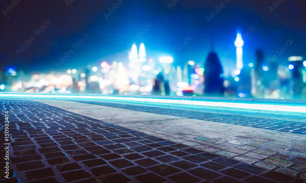 Empty marble floor with blue neon lights circulating underneath the stone with abstract blur bokeh c