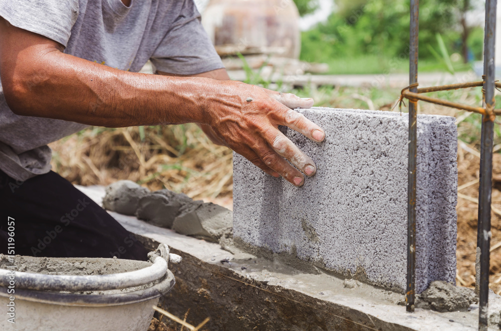  inbricklayer installing bricks  and Masonry work in construction