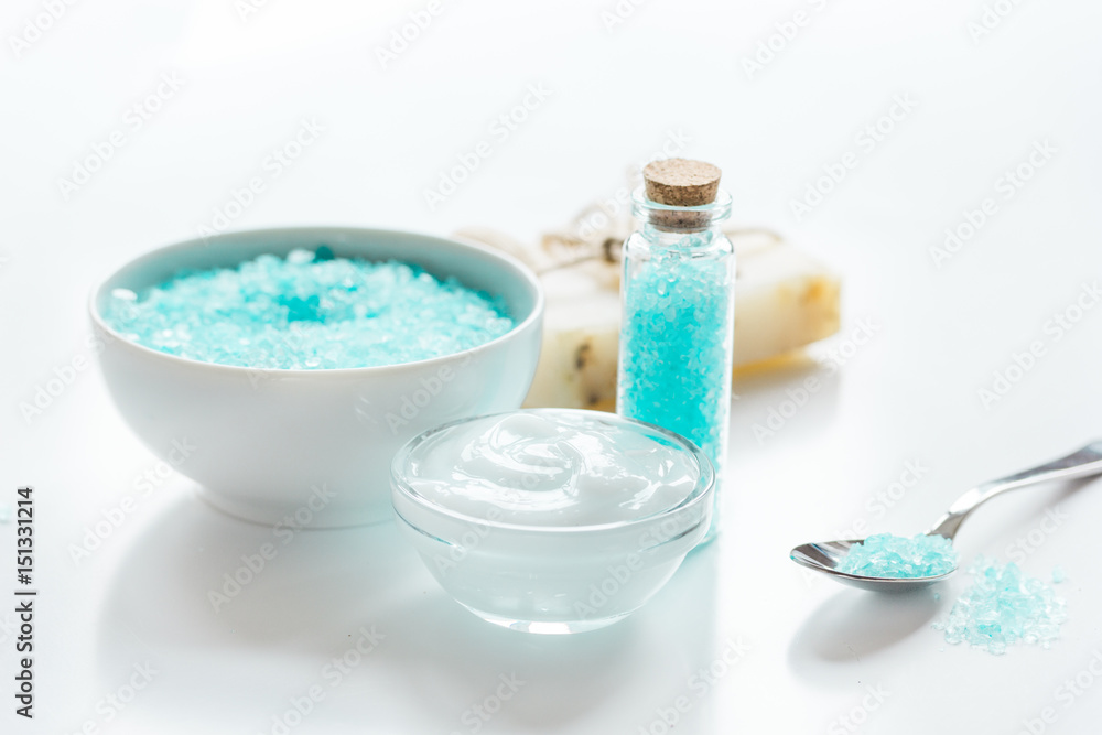 spa composition with blue sea salt and natural soap on white desk background