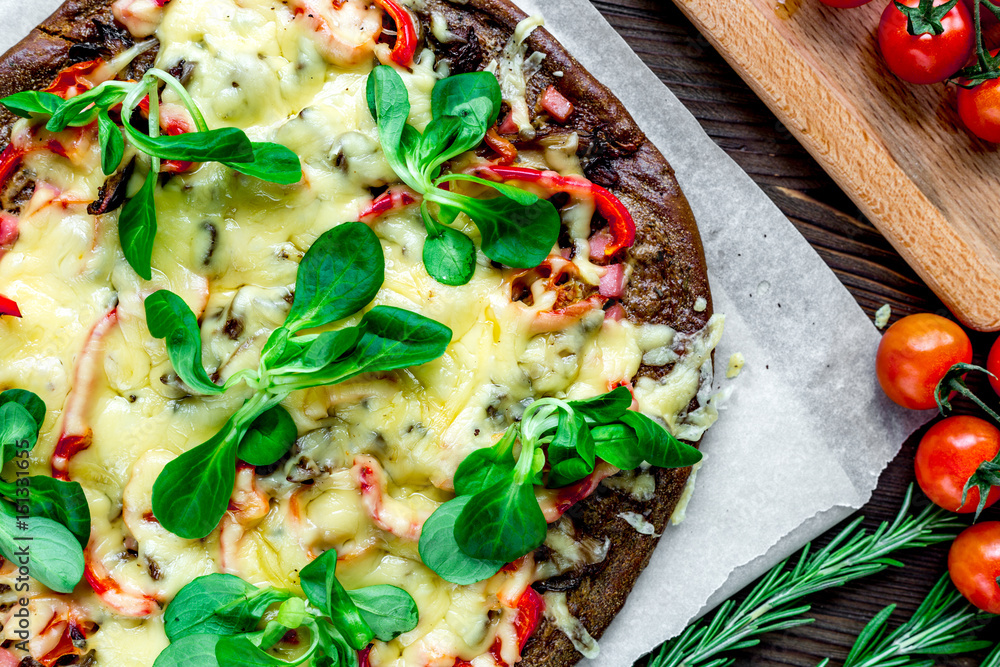 cooking pizza with vegetables and cheese on wooden desk background top view