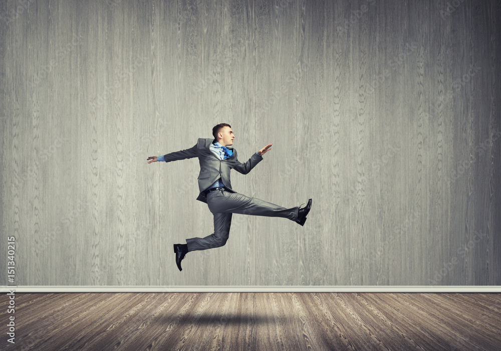 Businessman jumping high