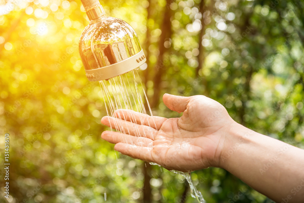 hand and droplets of water from shower