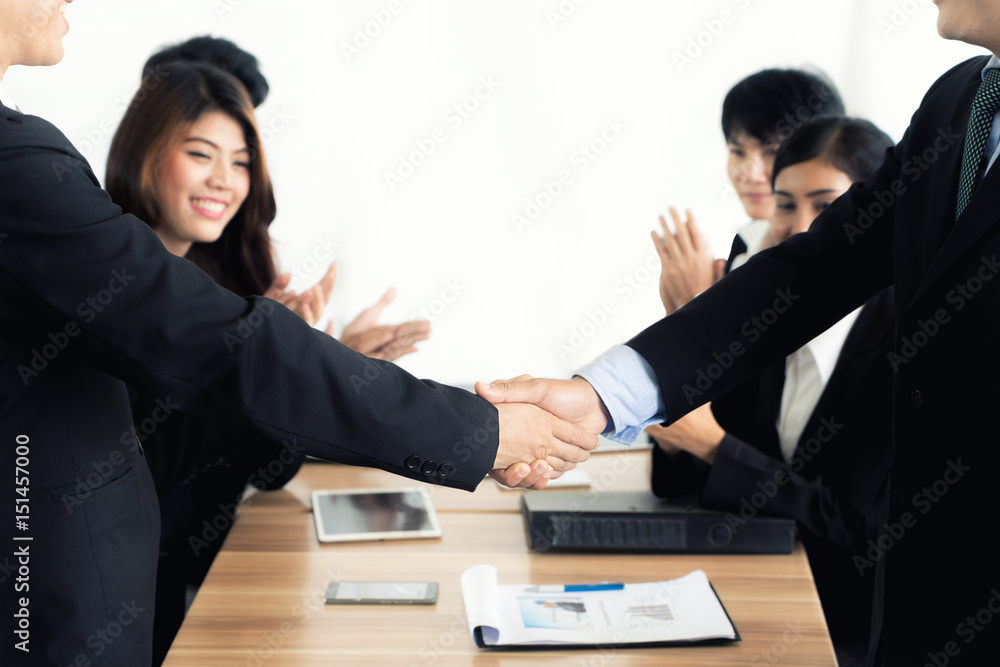 Asian businessman shaking hands in conference room. Business people shaking hands agreement concept.