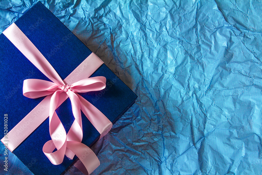 The Dark blue gift box with pink ribbon decoration on polka blue paper , Happy Fathers Day concept 