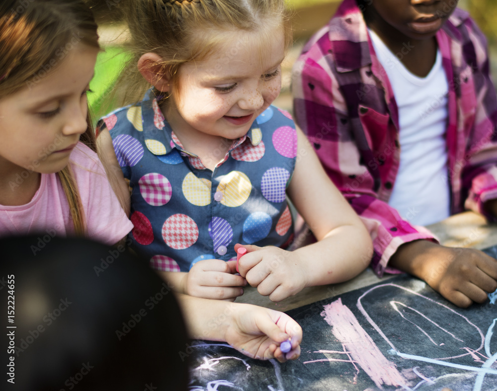 Group of kindergarten kids friends drawing art class outdoors