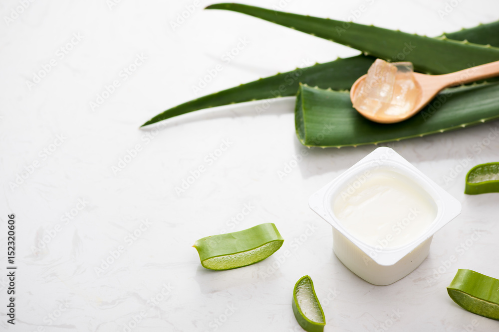 Aloe vera yogurt with fresh leaves on a wooden table