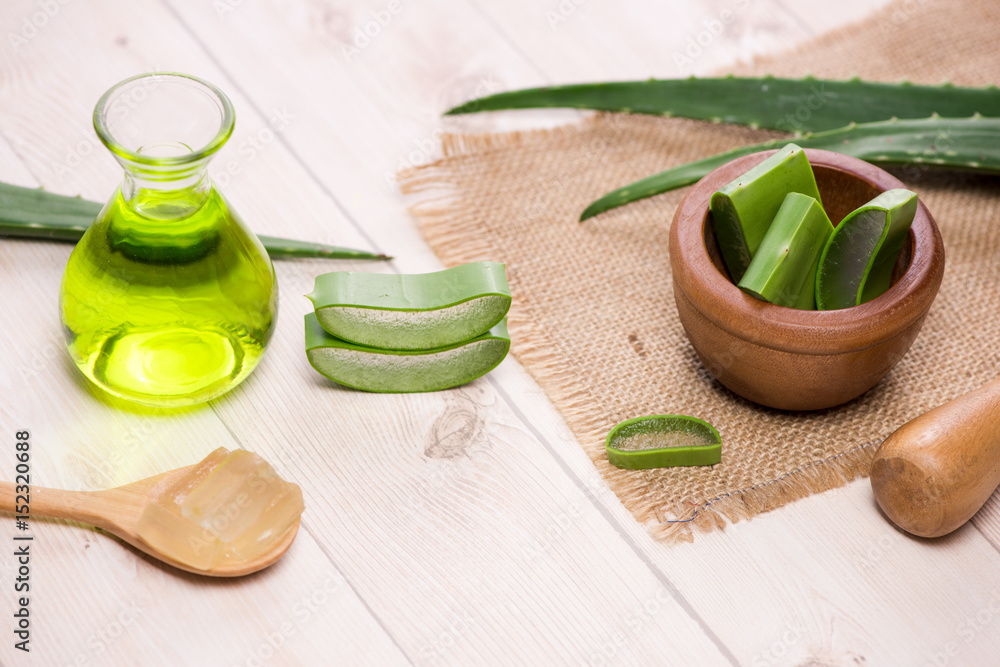 Aloe vera yogurt with fresh leaves on a wooden table