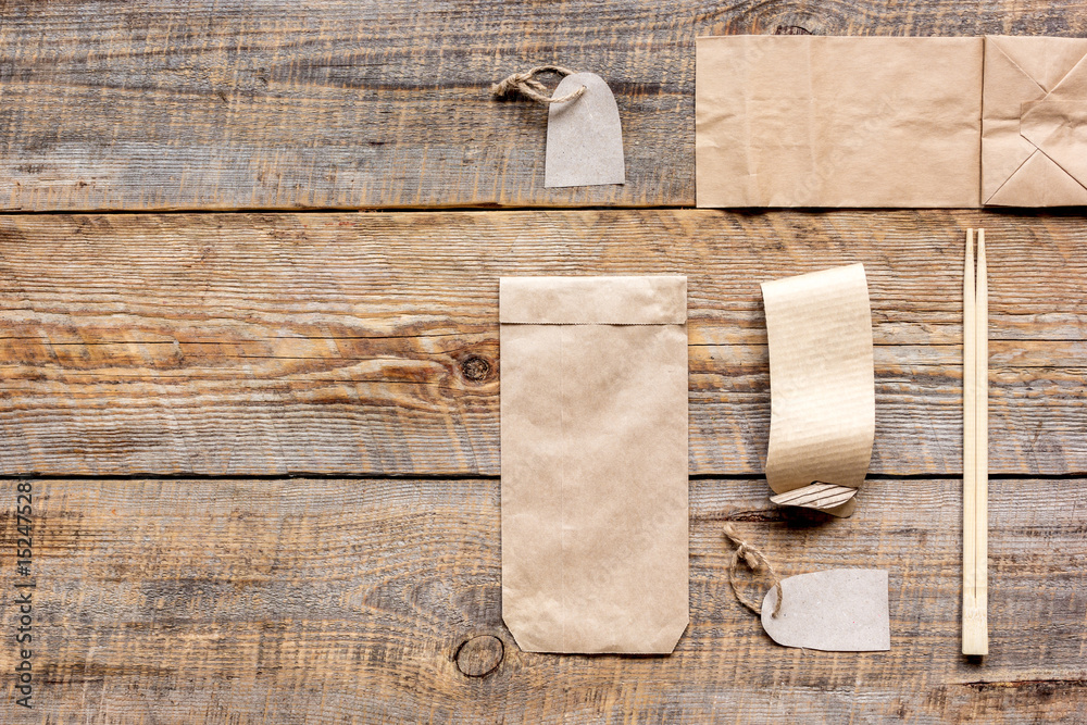 paper bags for food delivery restourant wooden table background top view mockup