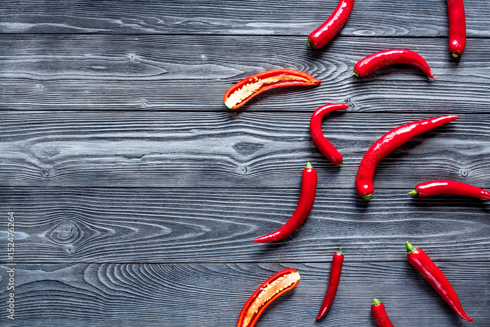 red chili pepper frame design on dark table background top view mock-up