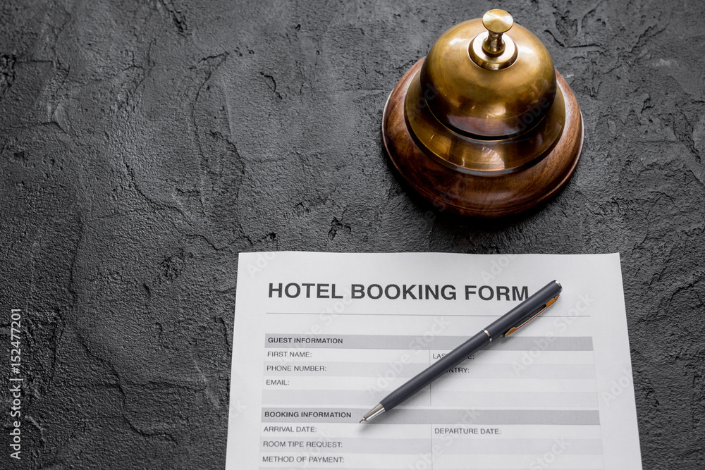 hotel reception desk with booking form dark background