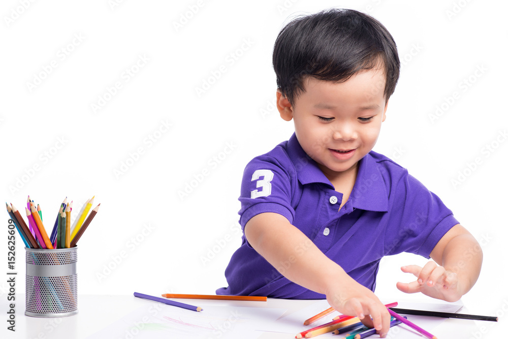 Portrait of cheerful boy drawing with colorful pencils