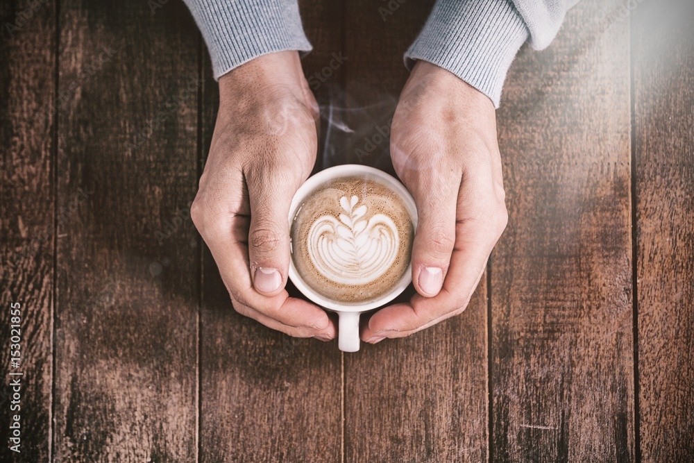 Cropped man holding white coffee cup