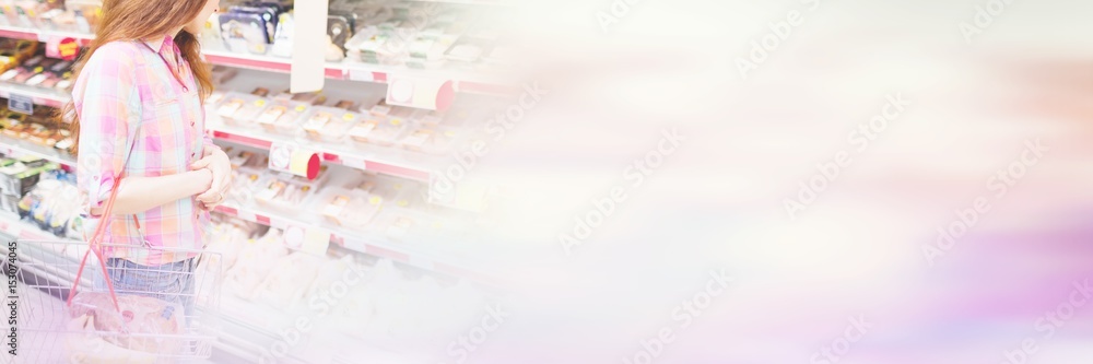 Woman doing grocery shopping while holding basket