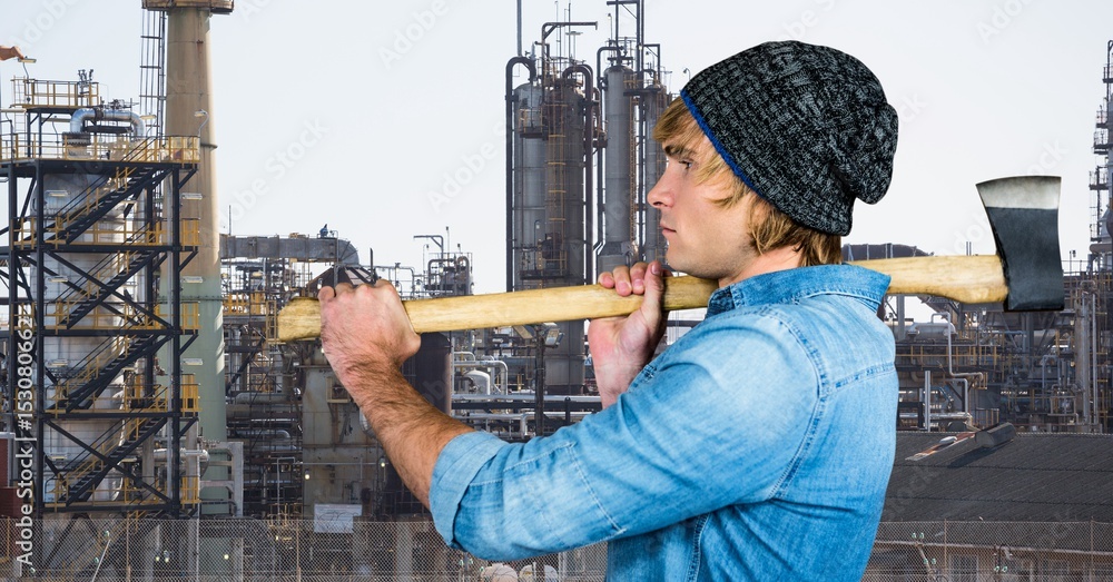 Side view of male hipster holding axe 