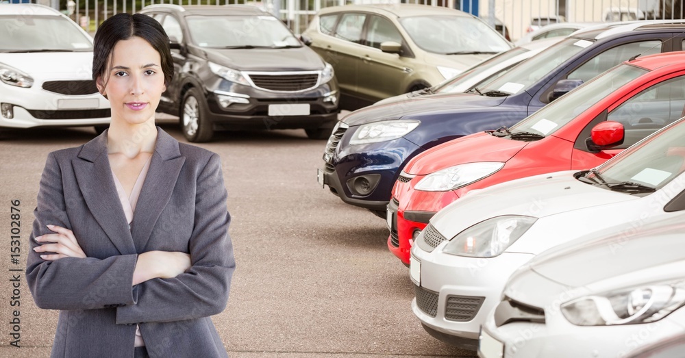 Woman standing arms crossed in car showroom