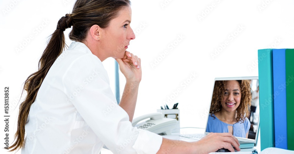 Woman video conferencing with colleague