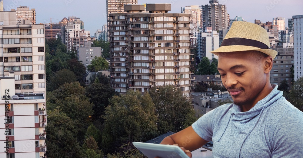 Man using digital tablet against cityscape