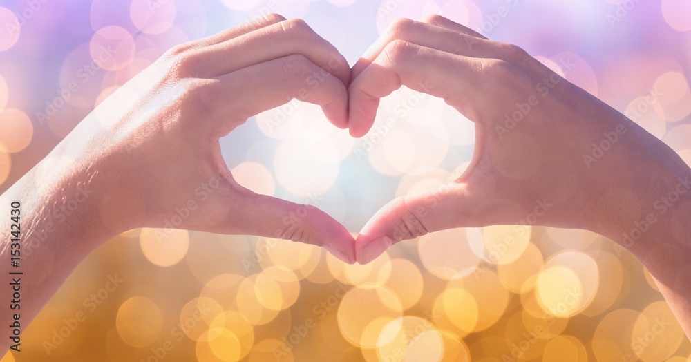 Cropped image of couple making heart shape 