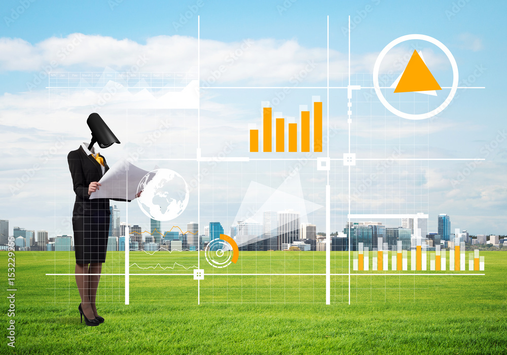 Camera headed woman standing on green grass against modern cityscape