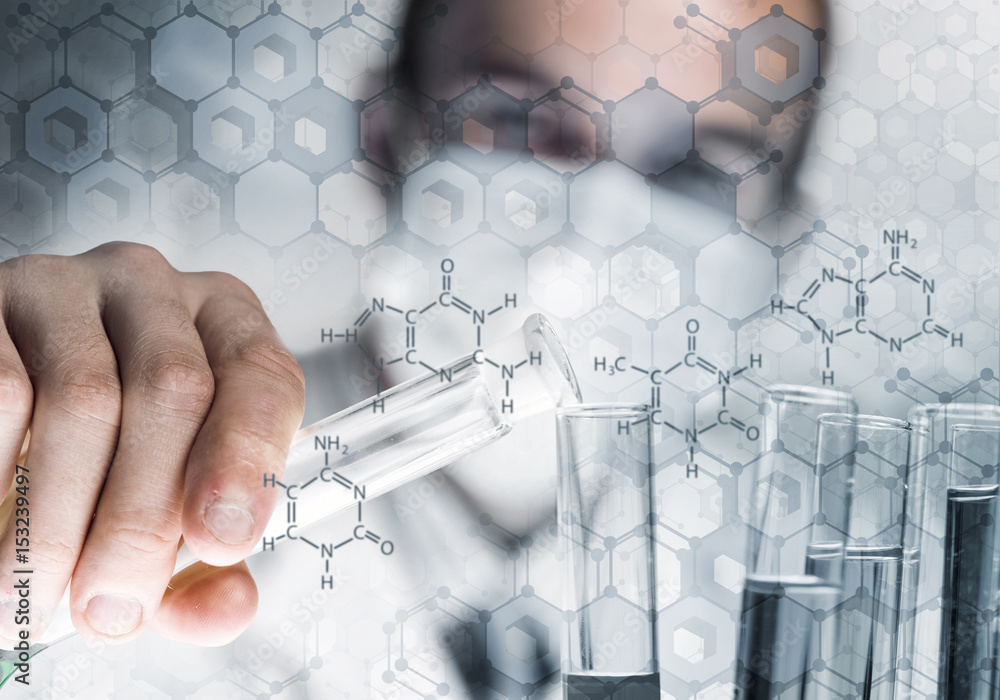 Young scientist mixing reagents in glass flask in clinical laboratory