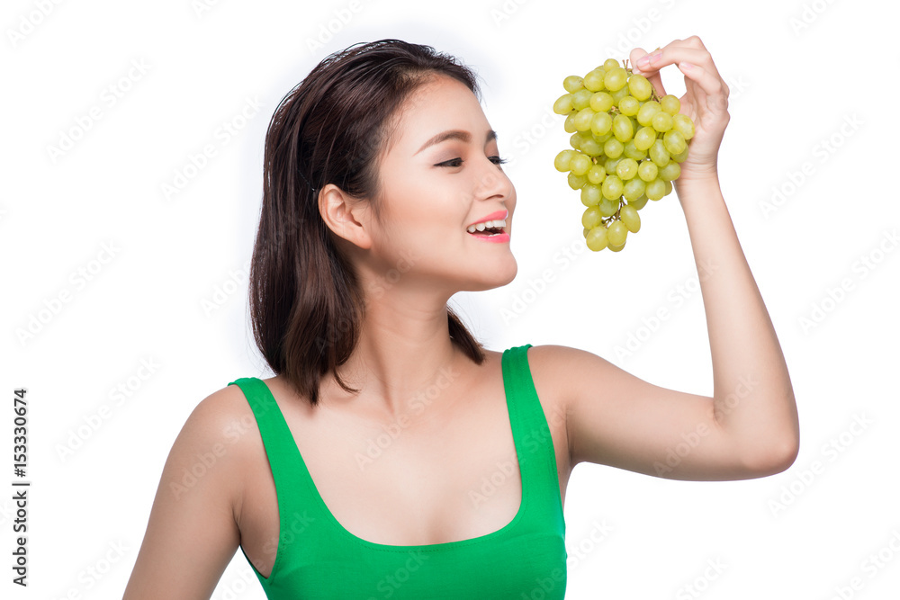 Young beautiful asian woman eating fresh grapes isolated on white background