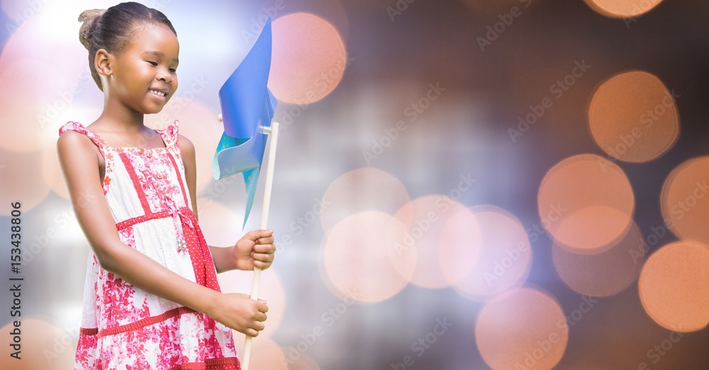 Smiling girl holding pinwheel