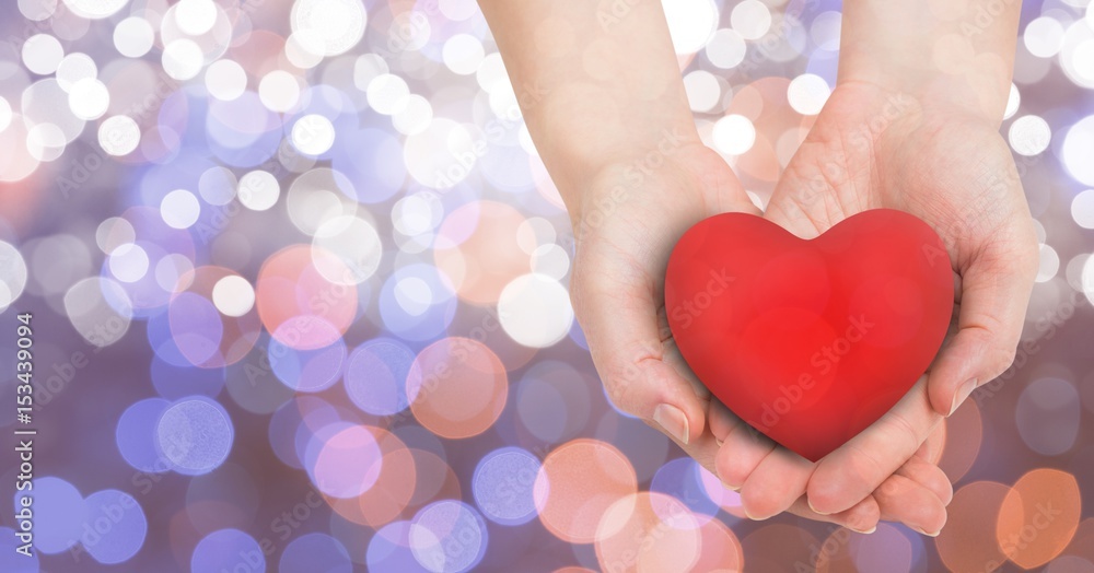 Close-up of females hands holding heart shape 