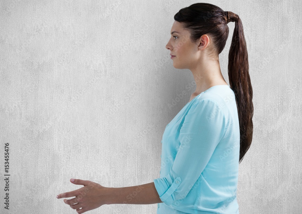 Side view of woman gesturing over wall