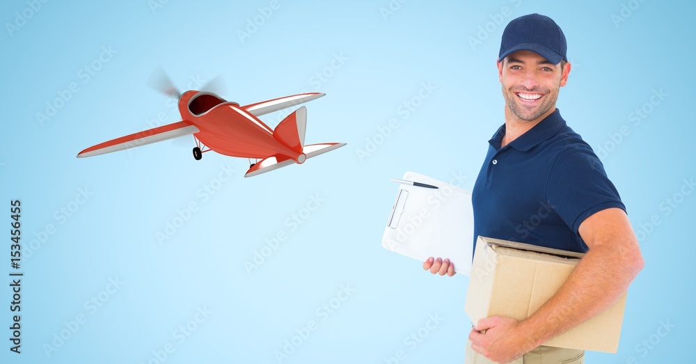 Delivery man carrying parcel against airplane