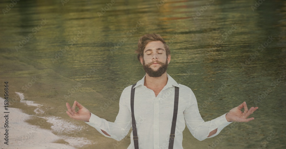 Double exposure of hipster meditating at shore