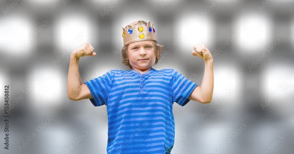 confident boy in king crown flexing muscles