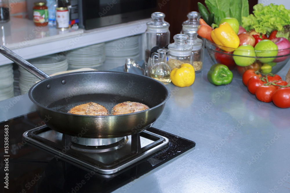  cooking fish in luxury kitchen