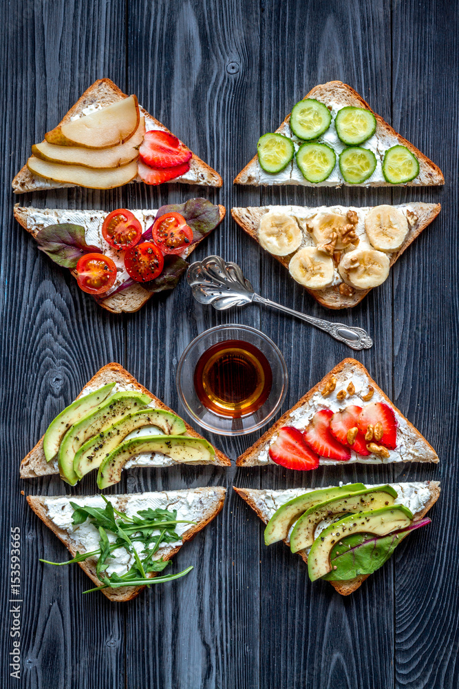 sandwiches set on dark table background top view