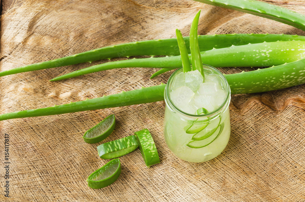 Aloe Vera plant sliced in glass on Coconut fiber background